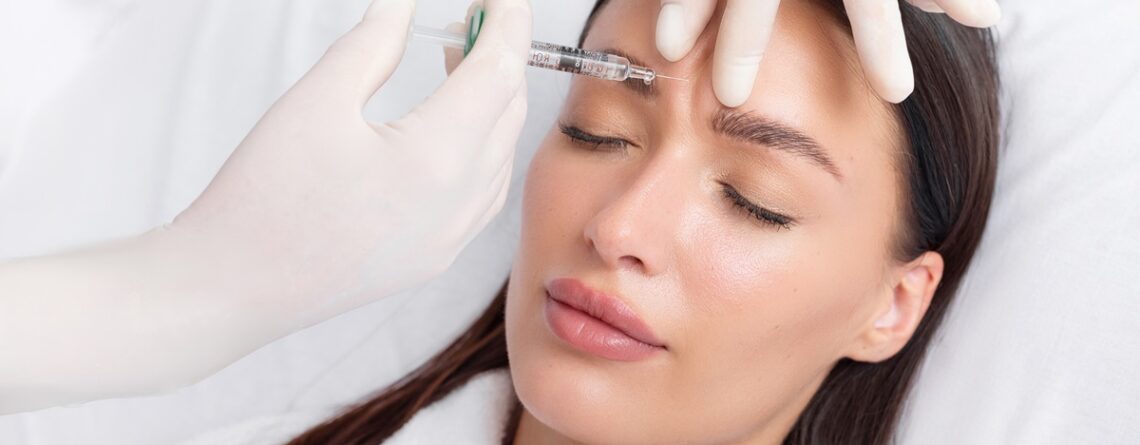 Nurse practitioner reviewing facial treatment areas with a first-time Botox patient at a med spa in Jericho, Long Island.