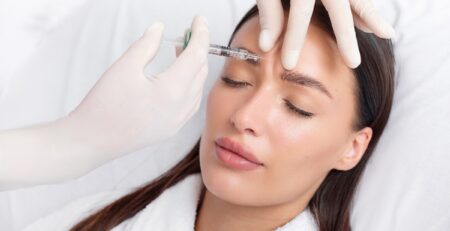 Nurse practitioner reviewing facial treatment areas with a first-time Botox patient at a med spa in Jericho, Long Island.