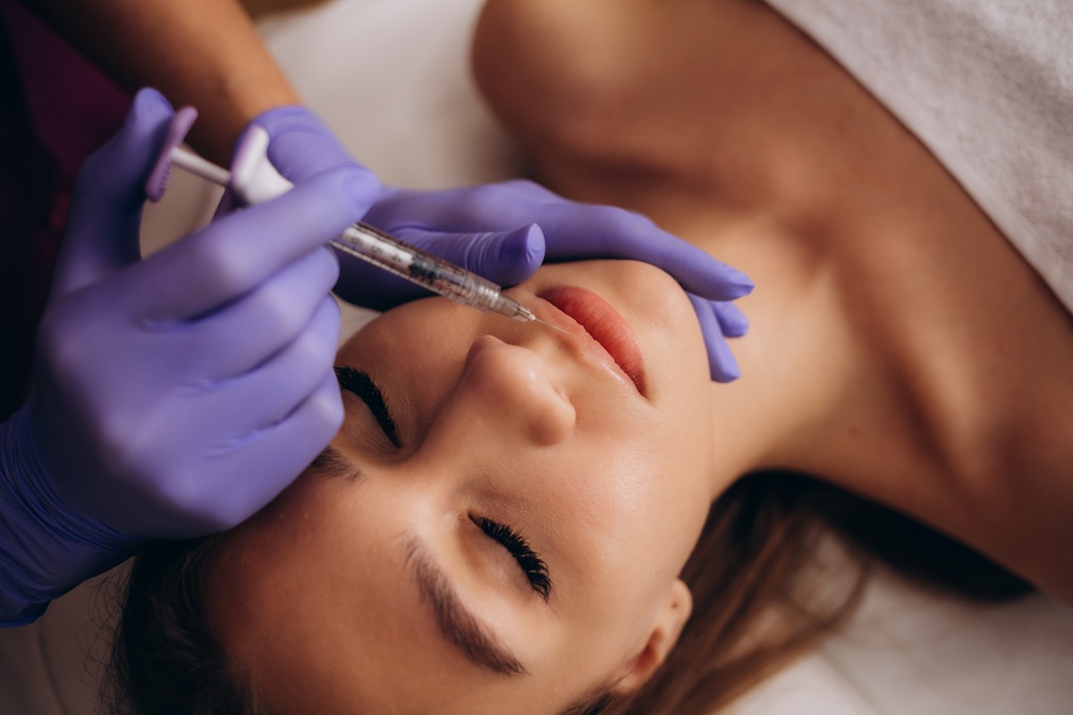 Professional,Female,Beautician,Makes,A,Rejuvenating,Injection,To,A,Young A woman consulting with an injector at a med spa in Jericho, Long Island