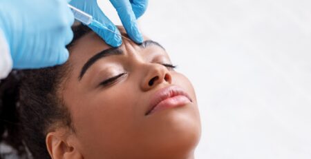 A relaxed woman receiving a Botox injection at a med spa in Jericho, Long Island, with a calm expression during treatment