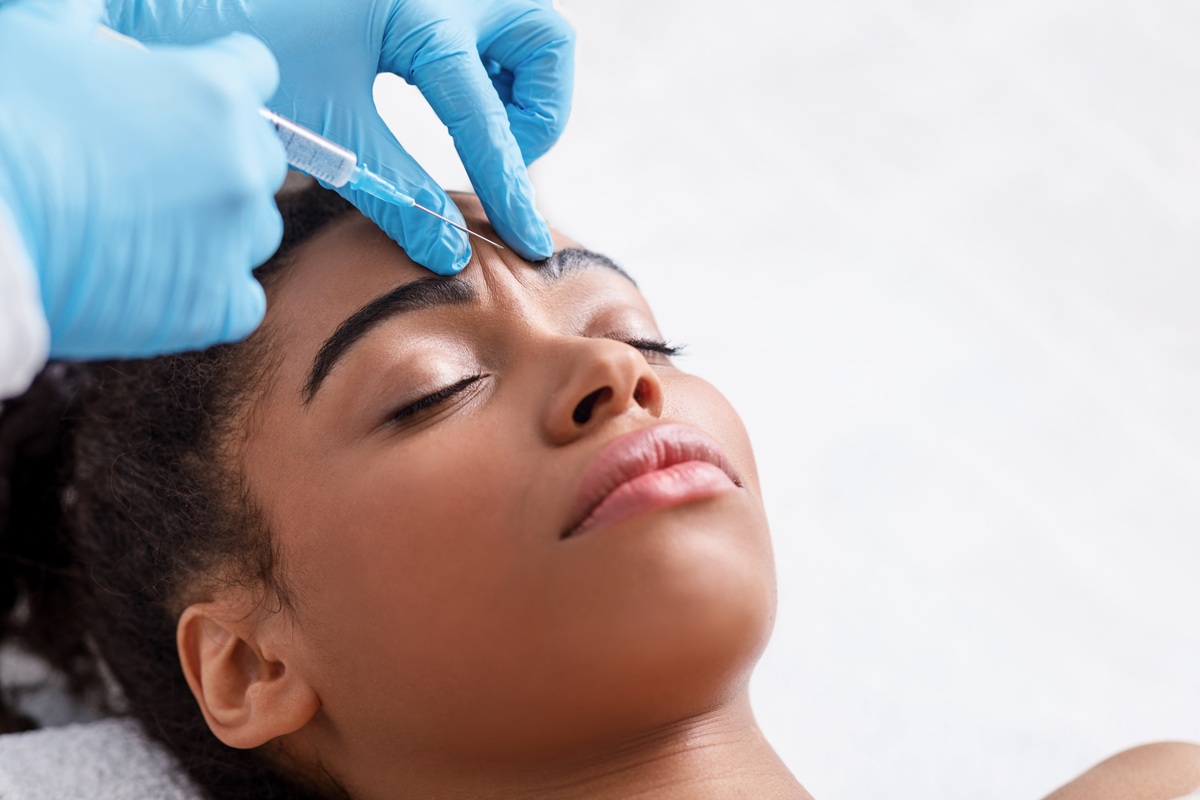 A relaxed woman receiving a Botox injection at a med spa in Jericho, Long Island, with a calm expression during treatment