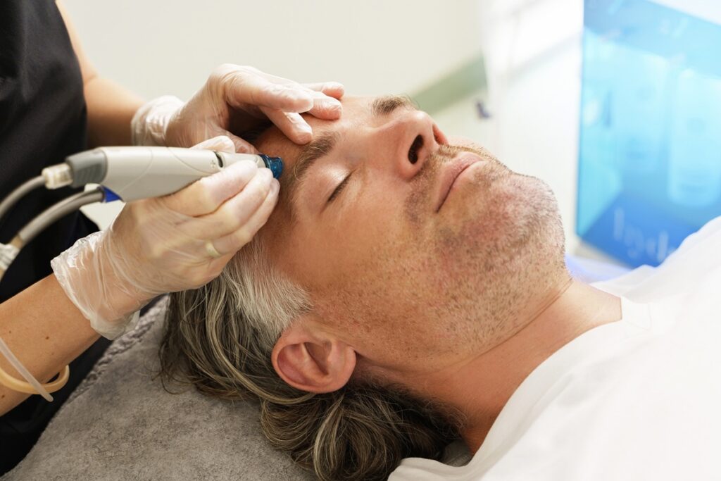 man receiving a hydrafacial treatment in long island