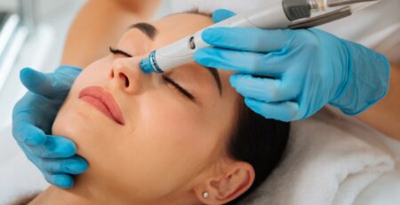 A woman receiving a HydraFacial treatment at a med spa in Jericho, Long Island, with a calm expression during the procedure