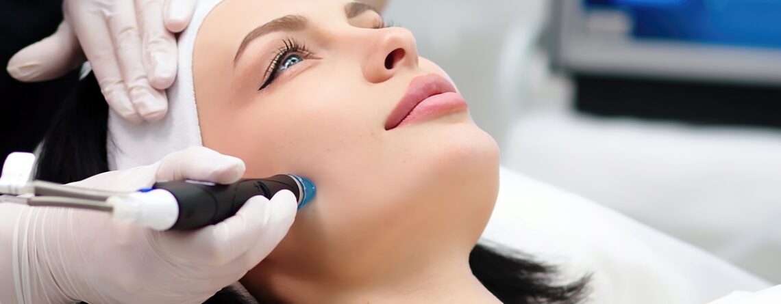 A woman receiving a HydraFacial treatment at a med spa in Jericho, Long Island, with smooth glowing skin